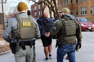 News Wrap: Suspect killed after driving car into ICE officers in Chicago suburb – PBS